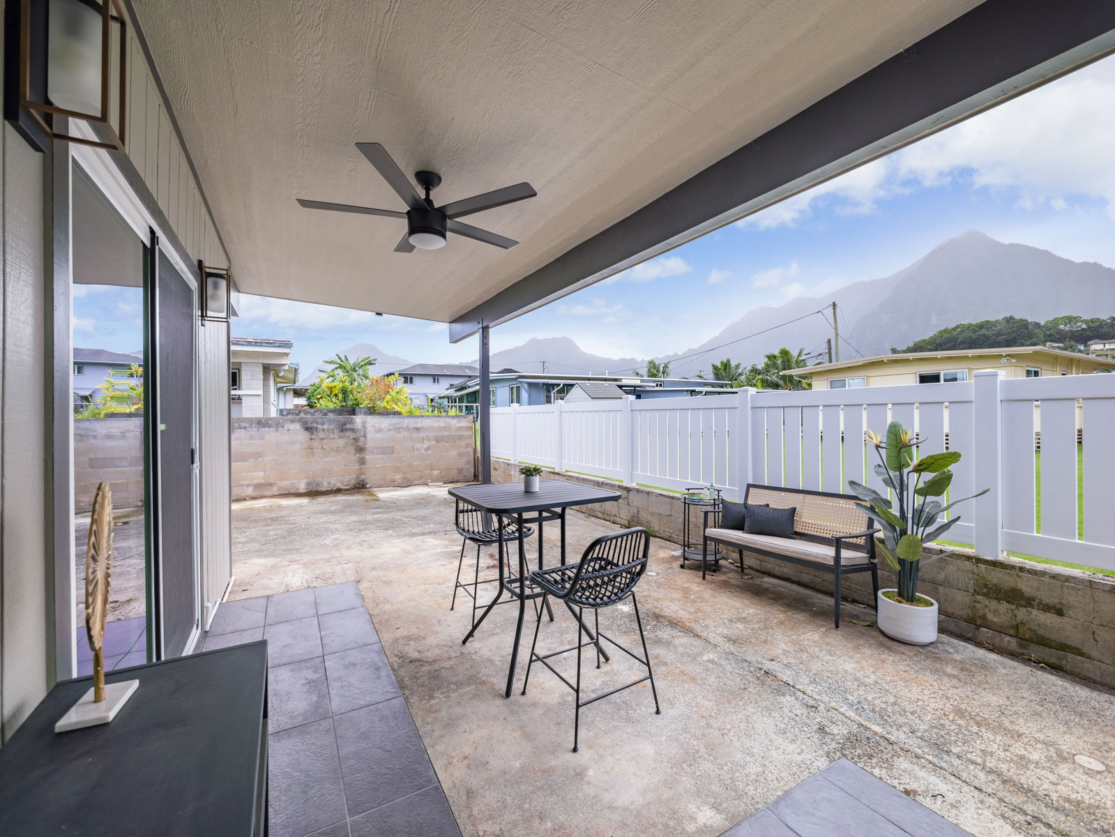 45-561 Paleka Road, Unit C Kaneohe, HI 96744 - Photo 23 of 27 a view of a patio with a table and chairs