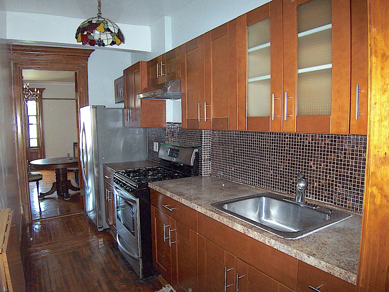 864 Prospect Place, Unit 2 Brooklyn, NY 11216 - Photo 5 of 6 a kitchen with a sink stove top oven and cabinets