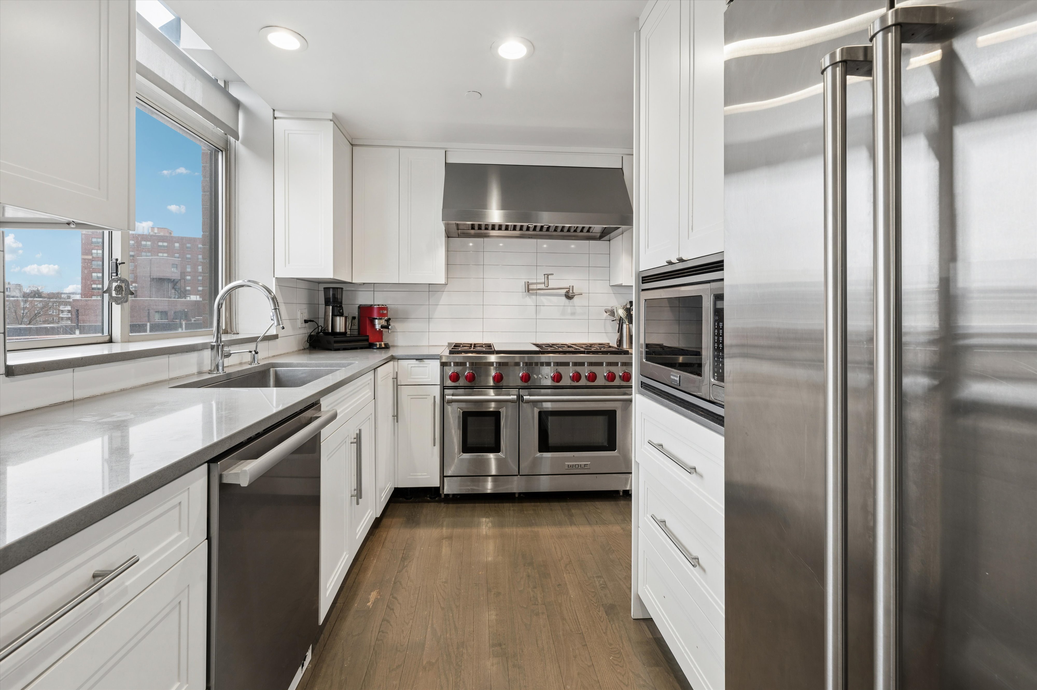 3625 Oxford Avenue, Unit 7C Bronx, NY 10463 - Photo 6 of 20 a kitchen with a sink cabinets and stainless steel appliances