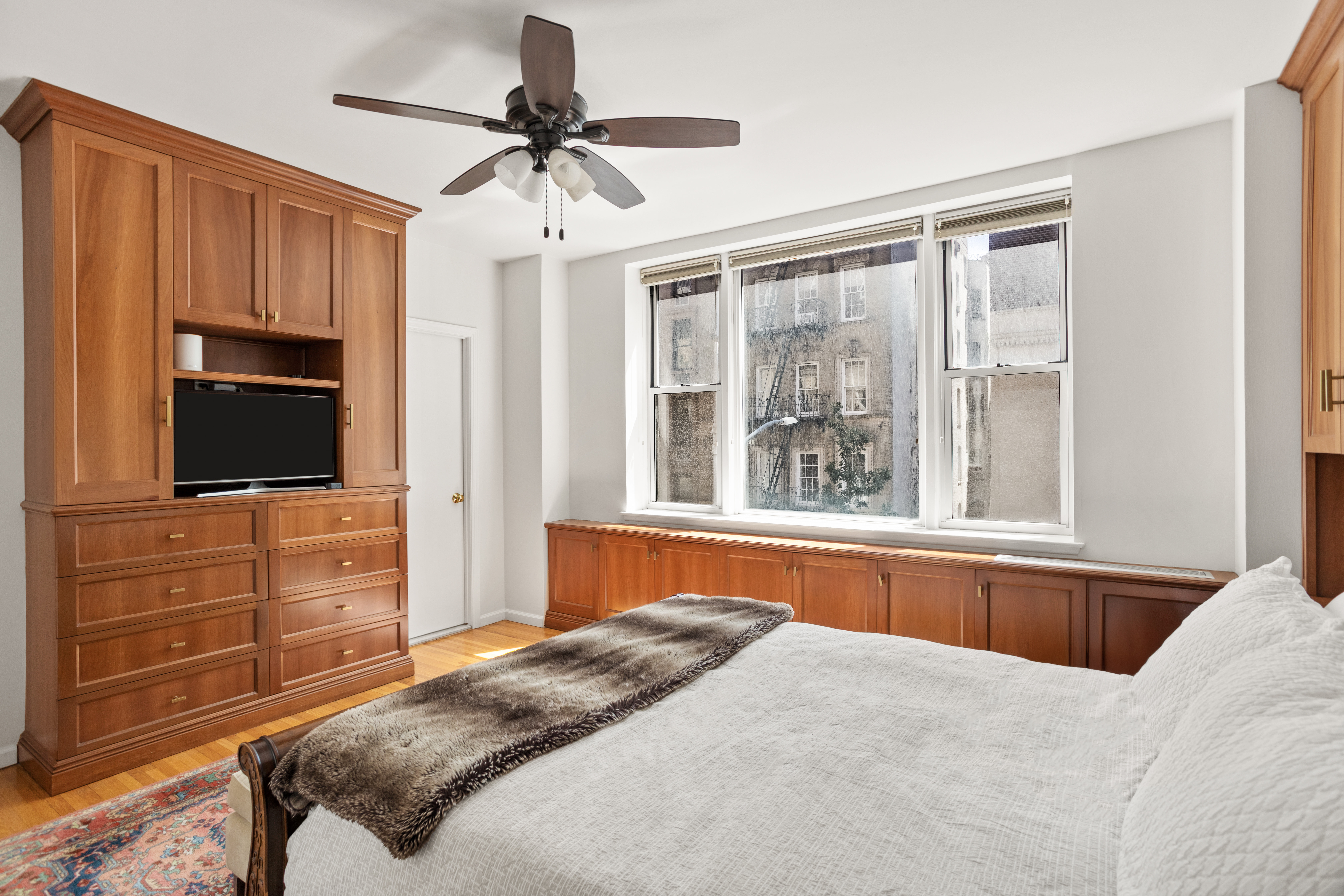 161 East 90th Street, Unit 3B Manhattan, NY 10128 - Photo 5 of 11 a bedroom with a bed and a flat screen tv