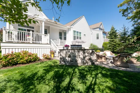 a front view of a house with swimming pool and garden