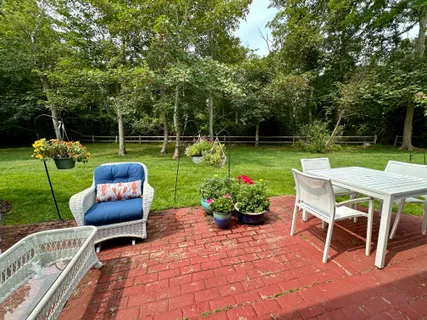 a view of a chair and tables back yard of the house