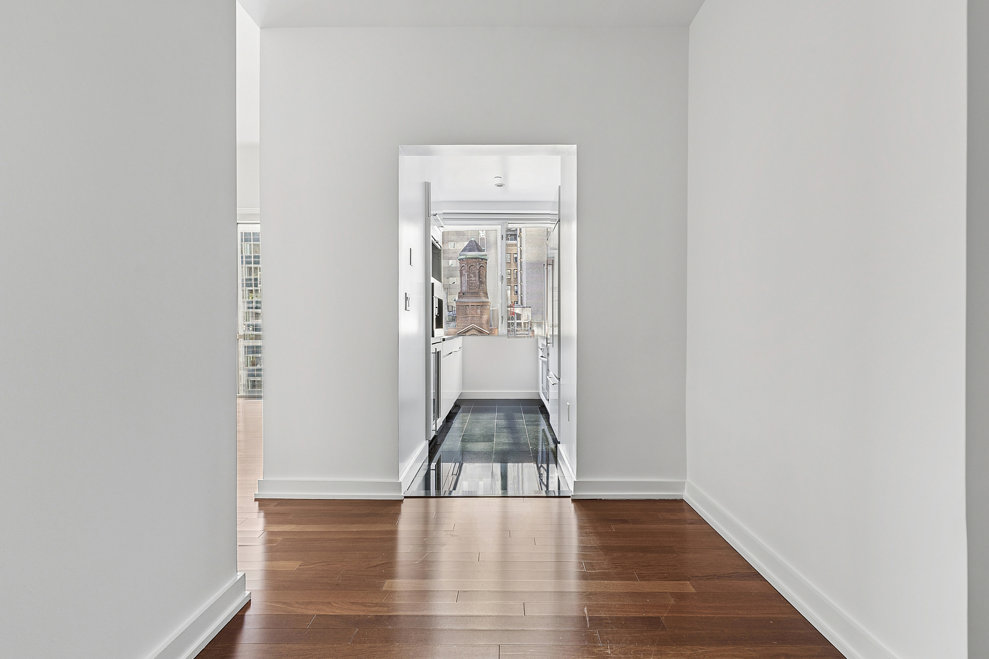 60 East 55th Street, Unit 20A Manhattan, NY 10022 - Photo 7 of 9 a view of an entryway with wooden floor
