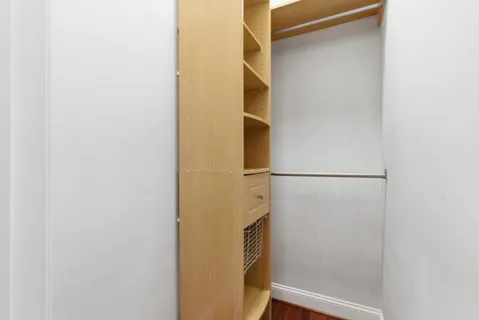 a view of walk in closet with empty room