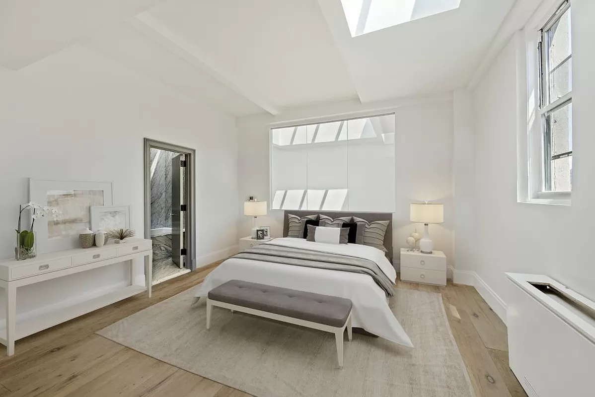 145 Spring Street, Unit PH Manhattan, NY 10012 - Photo 4 of 11 a bedroom with a bed and a large window