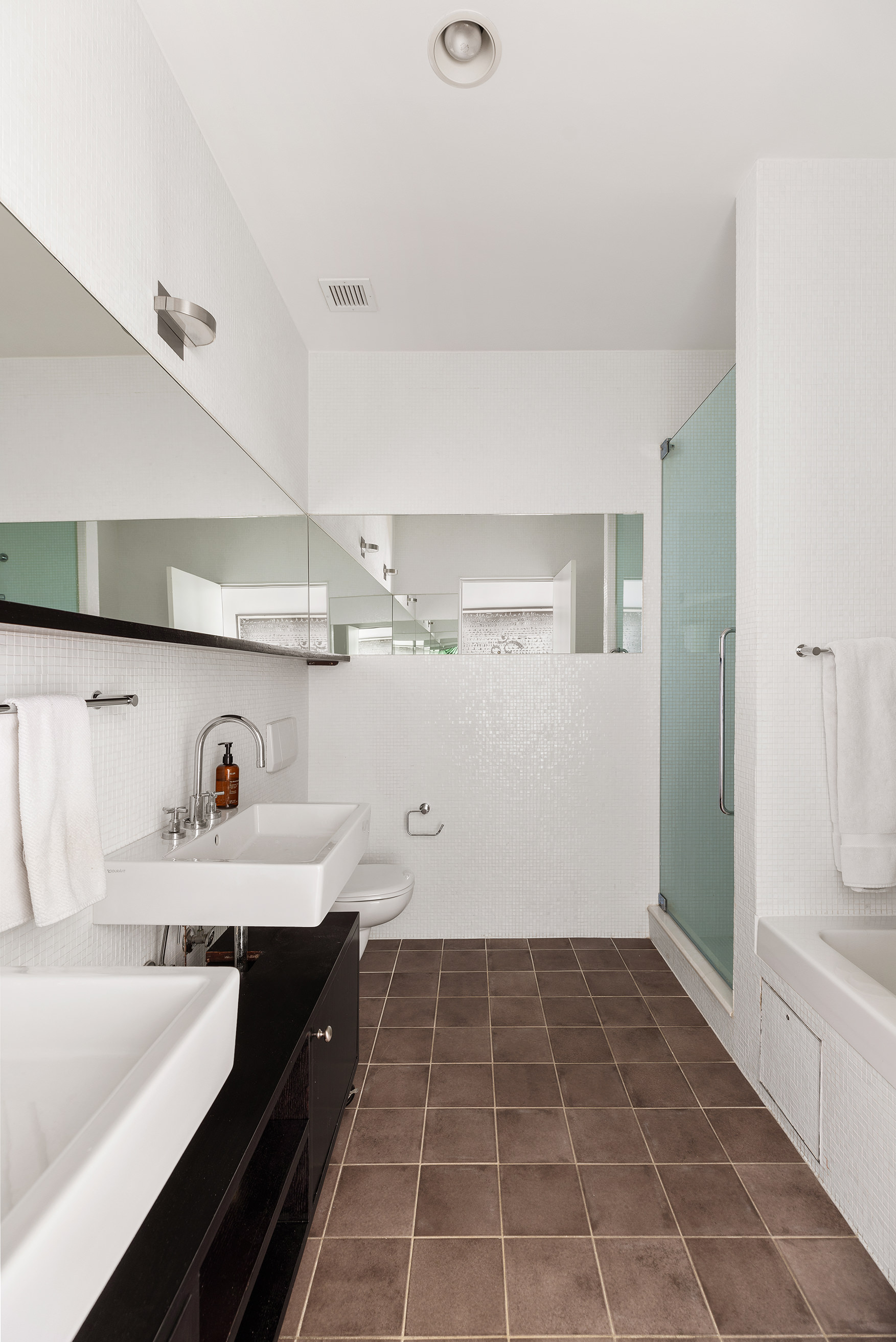 21 Astor Place, Unit 9E Manhattan, NY 10003 - Photo 6 of 10 a bathroom with a sink and a mirror