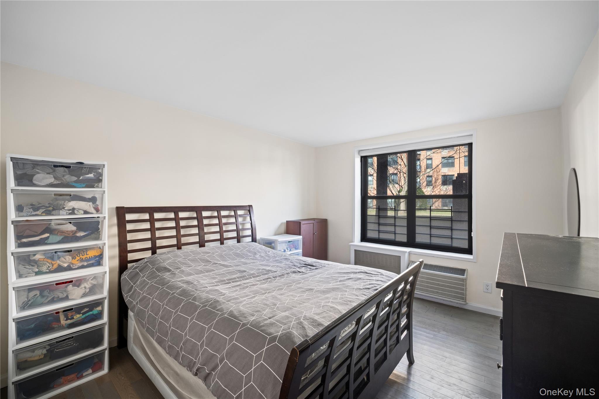 75-34 Bell Boulevard, Unit LD Queens, NY 11364 - Photo 16 of 26 a bedroom with a bed and a window with balcony view