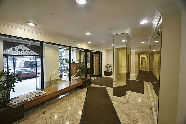 510 West 110th Street, Unit 2E Manhattan, NY 10025 - Photo 10 of 13 a lobby with a couch and a rug