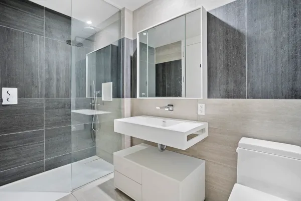 a bathroom with a sink toilet and shower