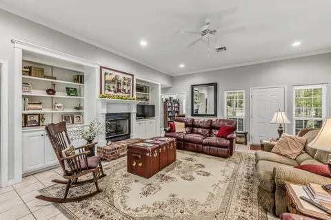 a living room with furniture a fireplace and a flat screen tv
