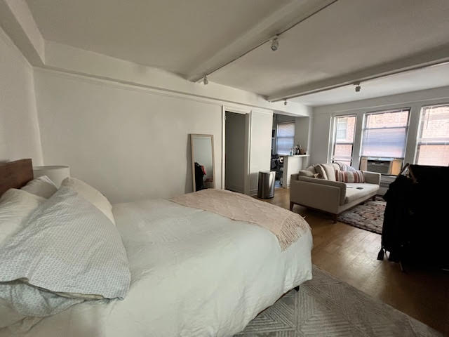 319 East 50th Street, Unit 10L Manhattan, NY 10022 - Photo 3 of 11 a spacious bedroom with a bed couch and a large window