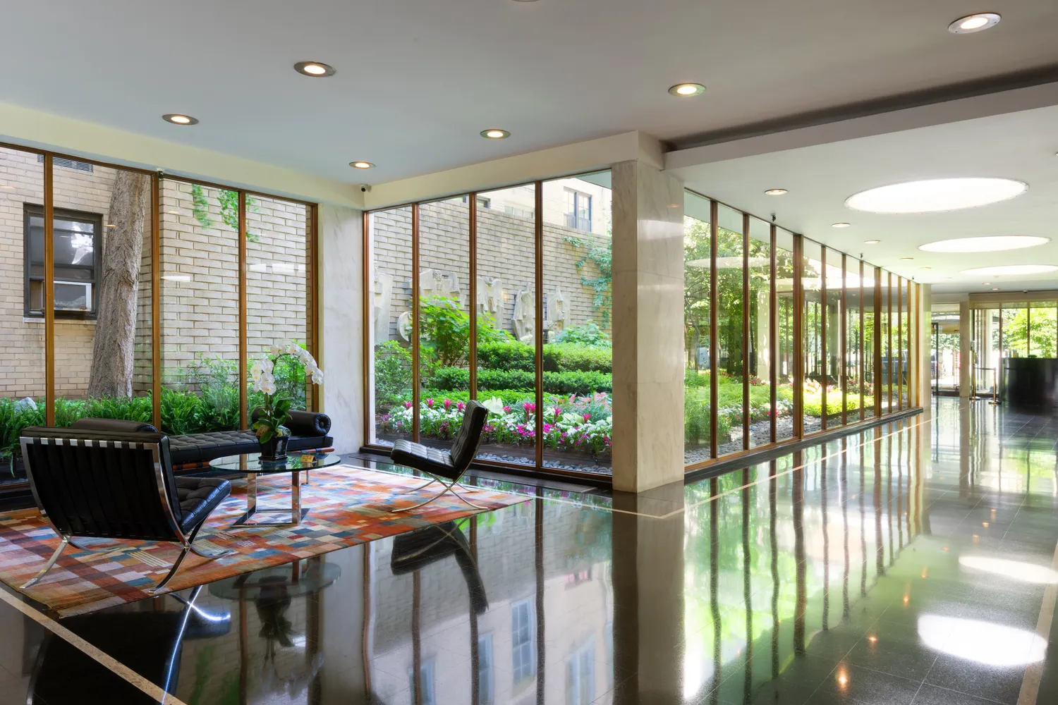 a outdoor space with furniture and floor to ceiling window