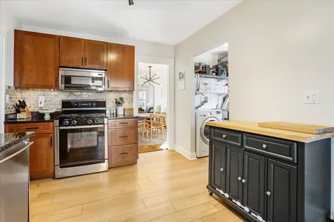 a kitchen with stainless steel appliances a stove microwave and refrigerator