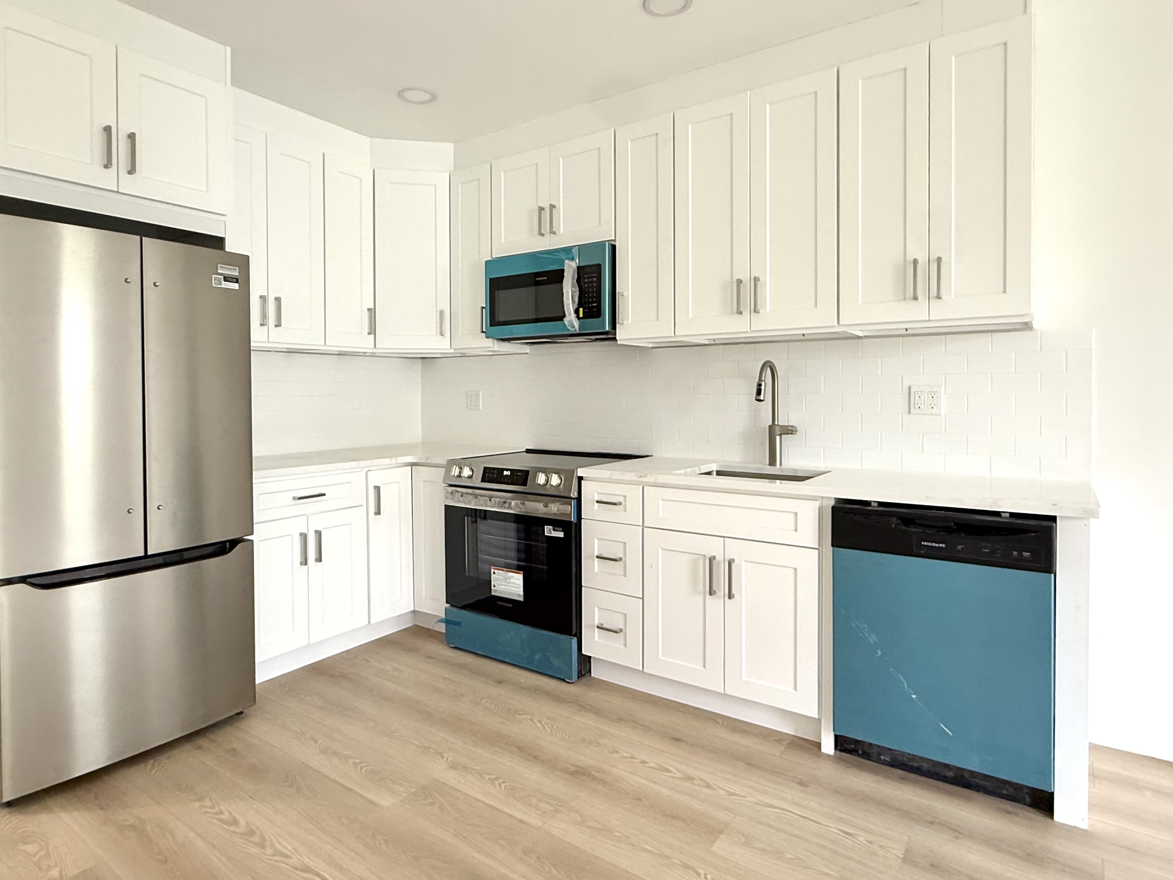985 Rogers Avenue, Unit 3 Brooklyn, NY 11226 - Photo 1 of 10 a kitchen with white cabinets and stainless steel appliances