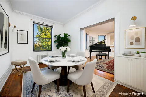 an empty room with window and wooden floor