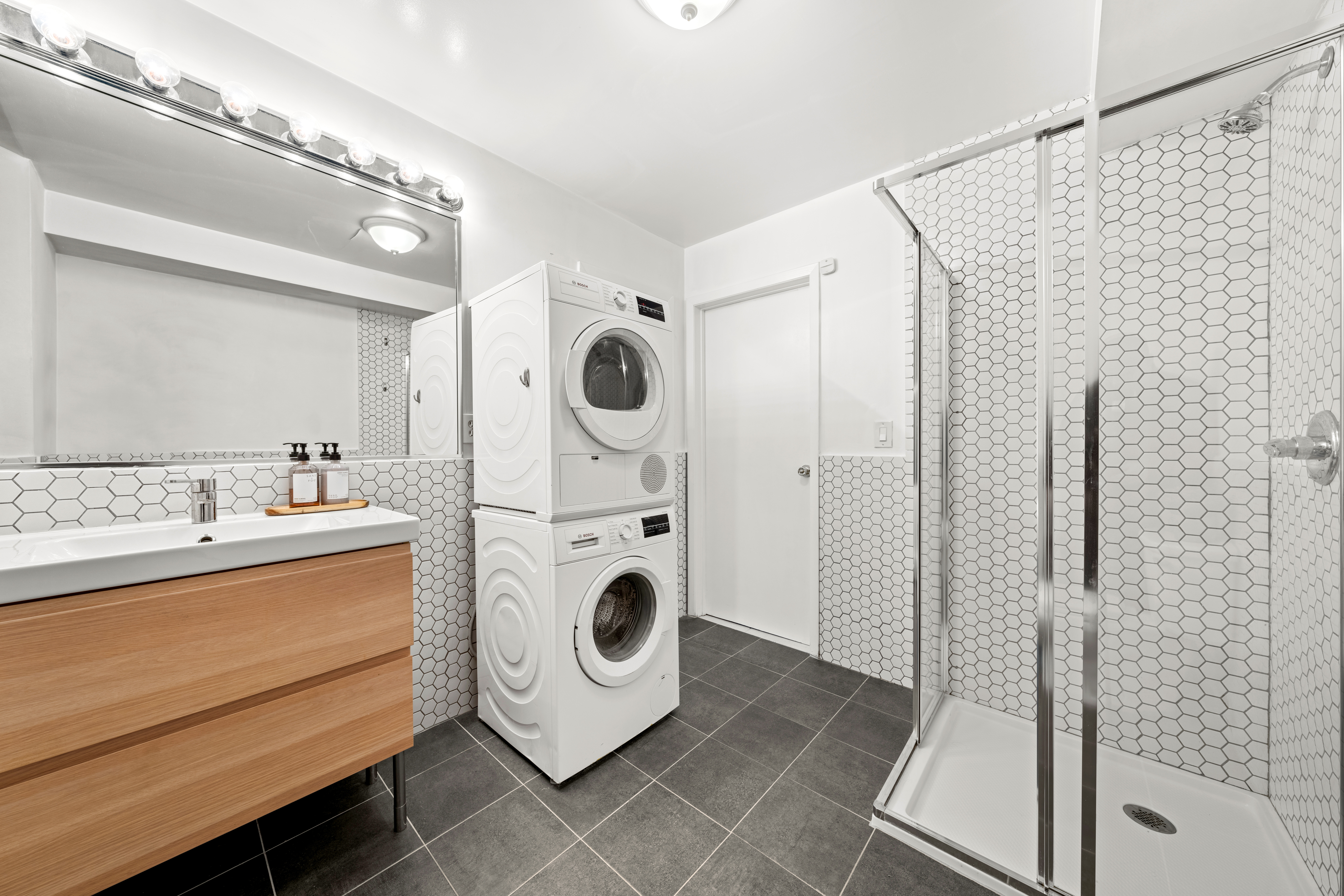 24 Harrison Street, Unit 3 Manhattan, NY 10013 - Photo 9 of 11 a utility room with dryer and washer