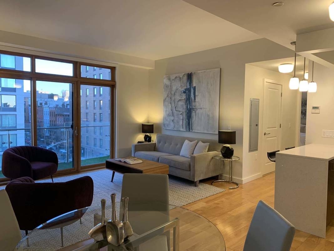 548 4th Avenue, Unit 4B Brooklyn, NY 11215 - Photo 5 of 22 a living room with furniture and a large window