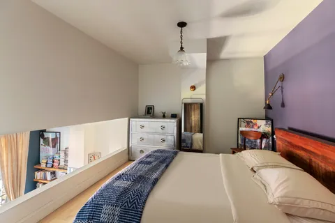 a bed room with a bed and a chandelier