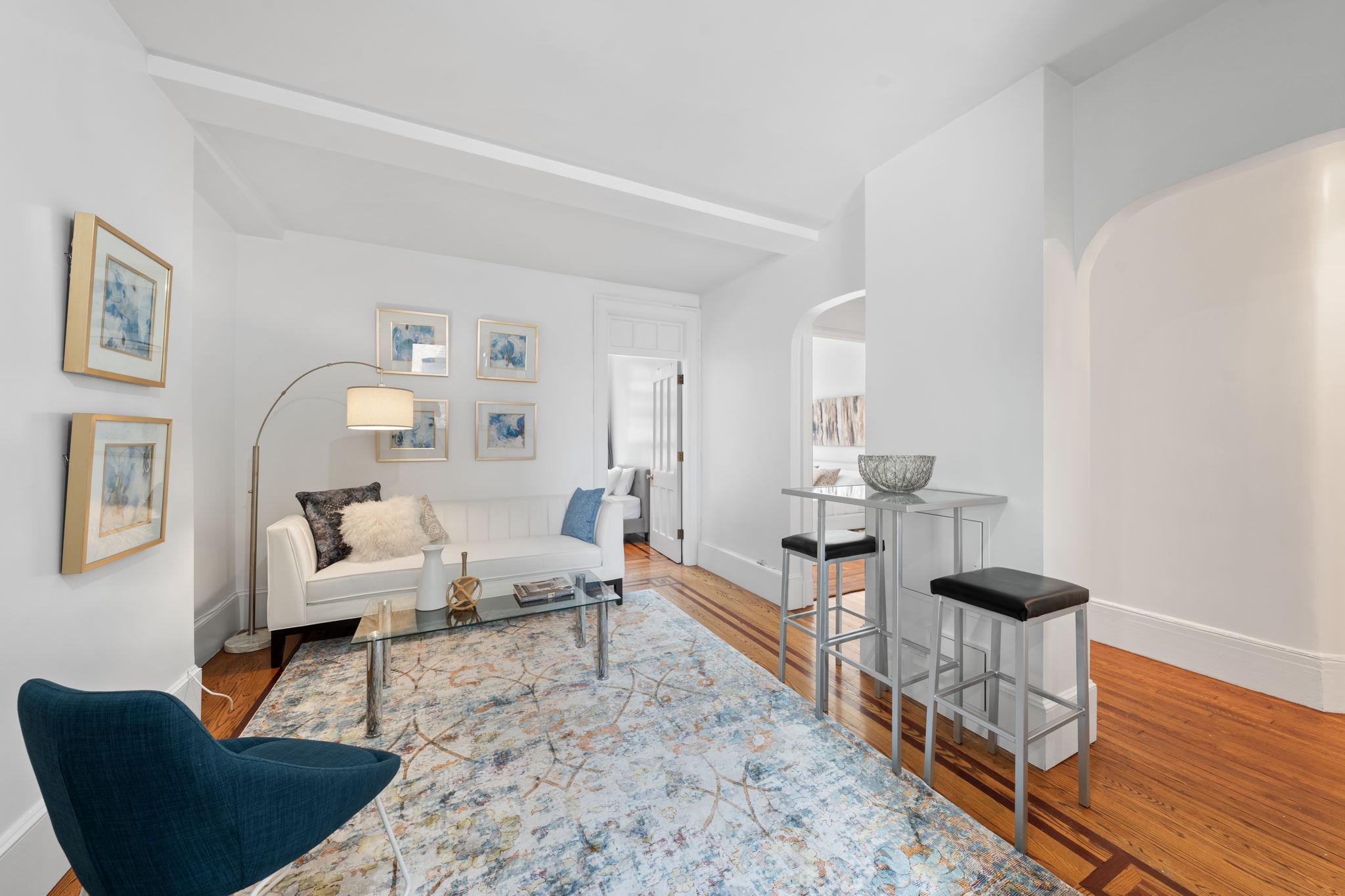a living room with furniture and wooden floor