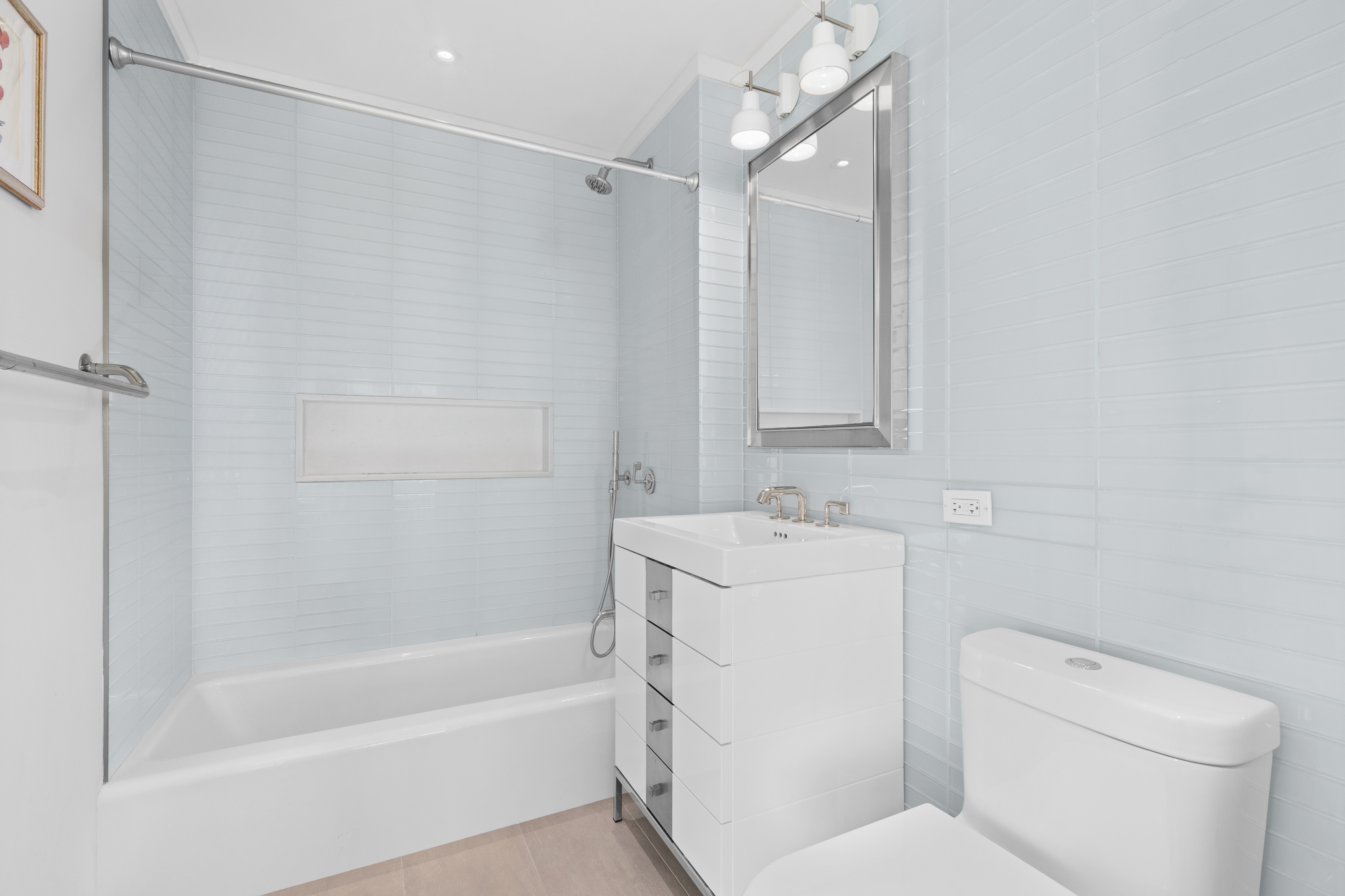 212 Warren Street, Unit 20A Manhattan, NY 10282 - Photo 20 of 23 a bathroom with a sink a toilet and shower