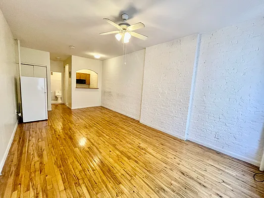 1105 1st Avenue, Unit 9 Manhattan, NY 10065 - Photo 2 of 8 a view of kitchen with wooden floor