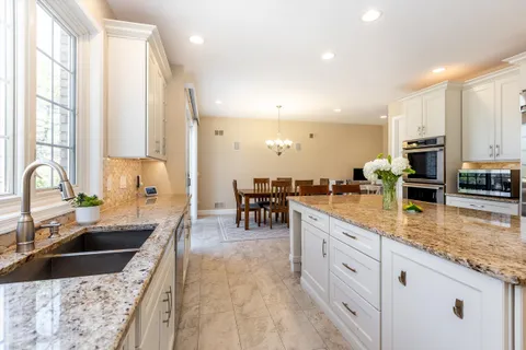 a kitchen with stainless steel appliances granite countertop a sink counter space and a stove