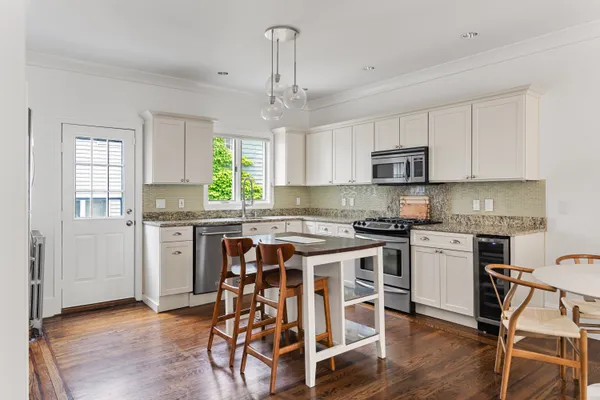 a kitchen with a stove a sink and a refrigerator