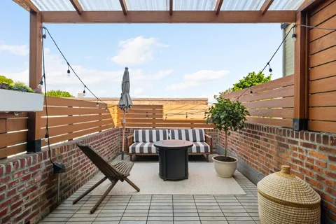 a view of a balcony with chair and wooden floor