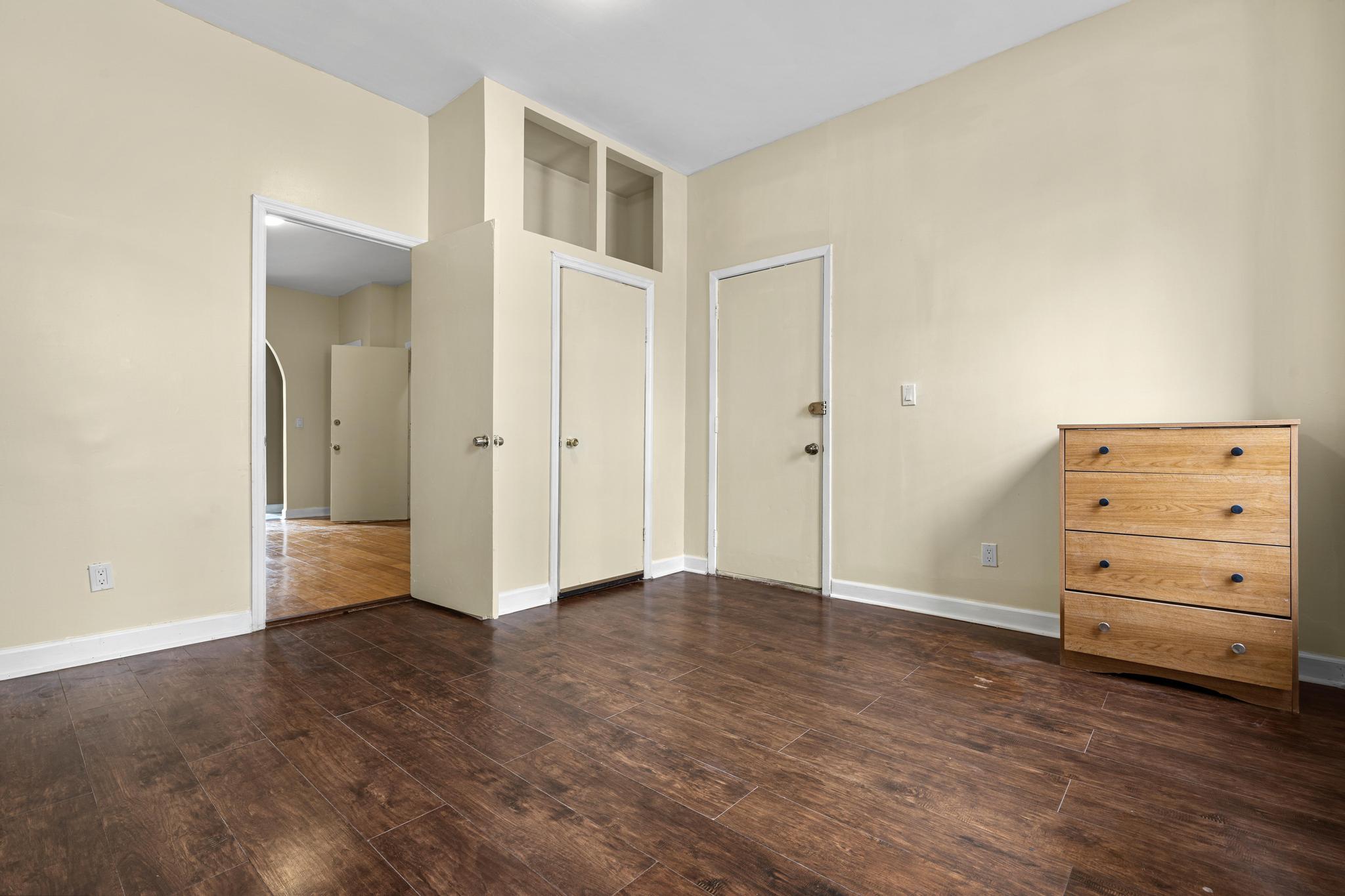 1328 Herkimer Street, Unit 1 Brooklyn, NY 11233 - Photo 5 of 9 an empty room with furniture and wooden floor