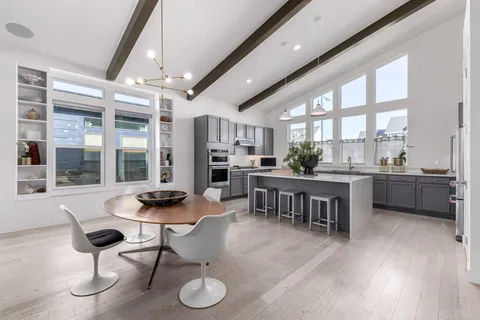 a living room with couches painting on the wall and a flat screen tv