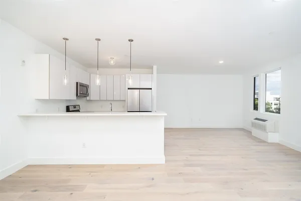 a view of kitchen with stainless steel appliances granite countertop refrigerator sink and stove