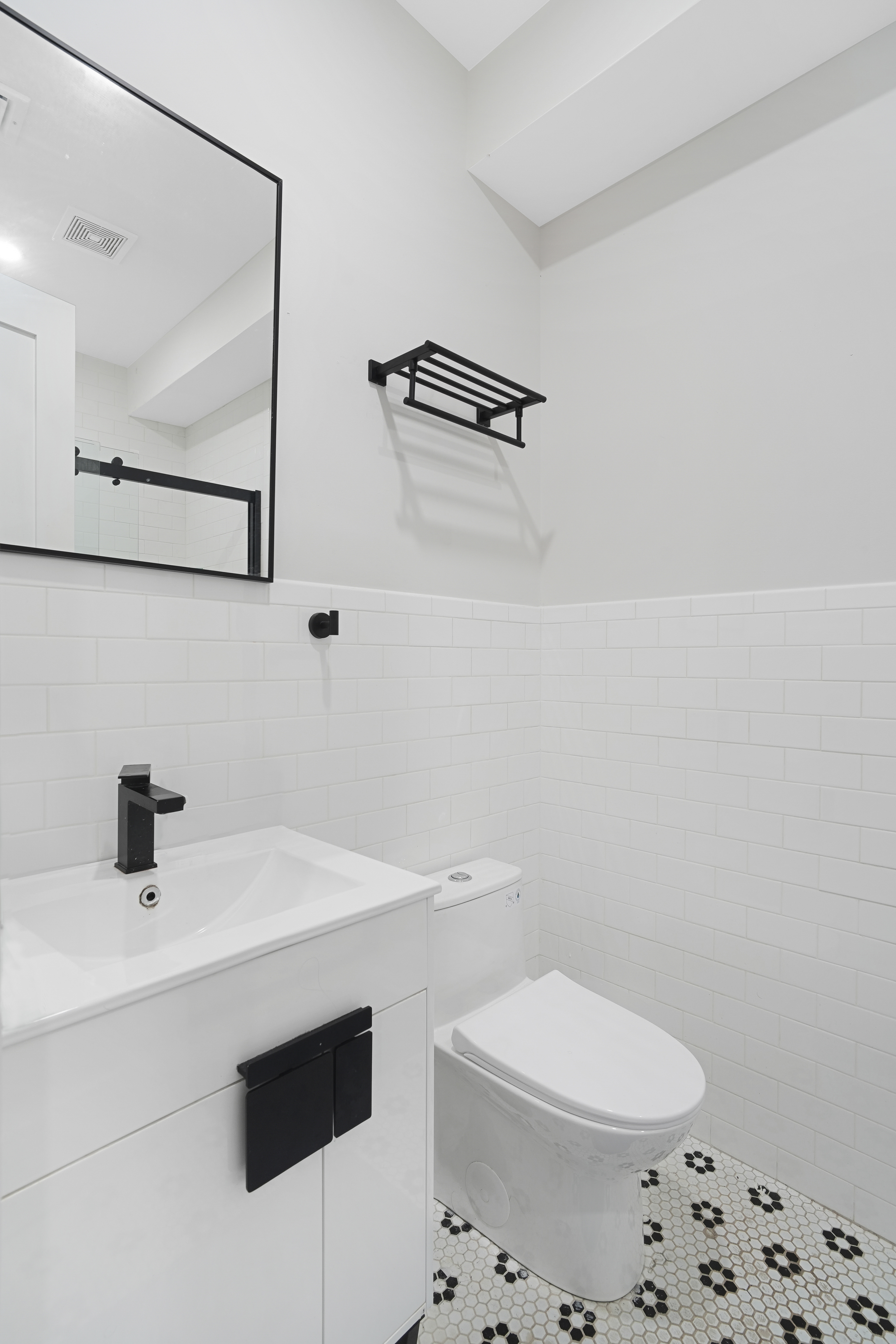 1390 Eastern Parkway Brooklyn, NY 11233 - Photo 15 of 19 a bathroom with a sink a toilet and a mirror