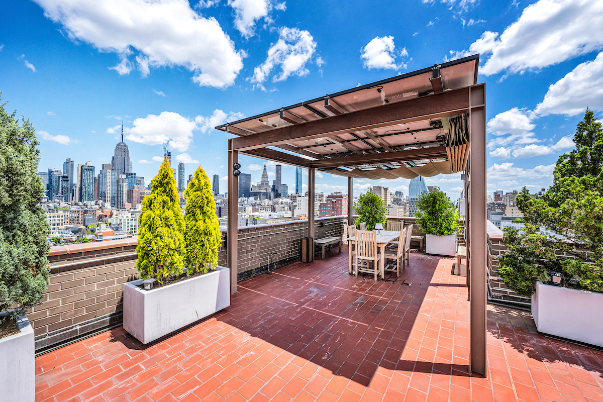77 7th Avenue, Unit 9E Manhattan, NY 10011 - Photo 8 of 9 a view of a patio with table and chairs potted plants with wooden floor