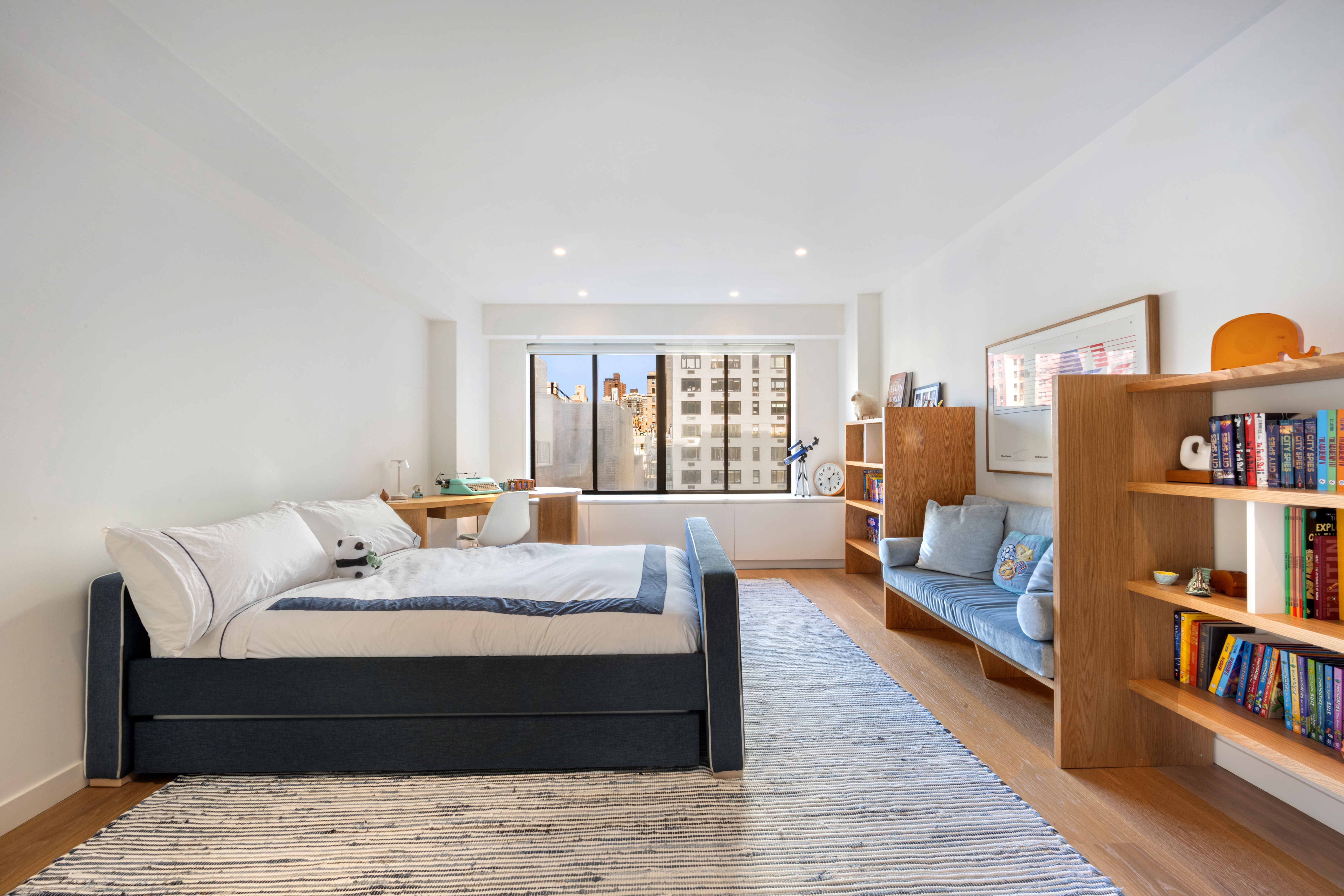 900 Park Avenue, Unit 7ABCE Manhattan, NY 10075 - Photo 12 of 18 a large bedroom with a bed and a book shelf