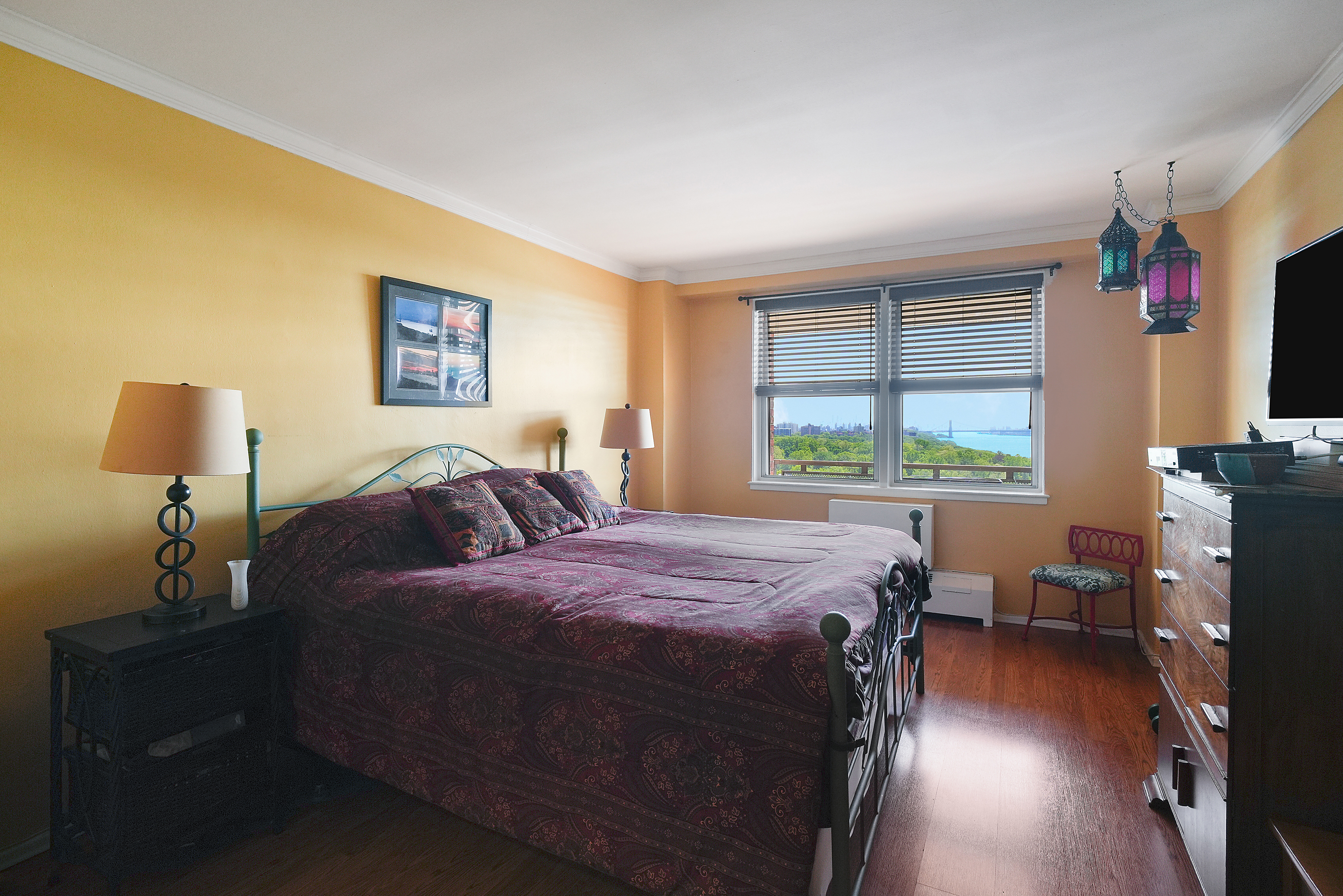 5700 Arlington Avenue, Unit 16T Bronx, NY 10471 - Photo 7 of 16 a bed sitting in a bedroom next to a window