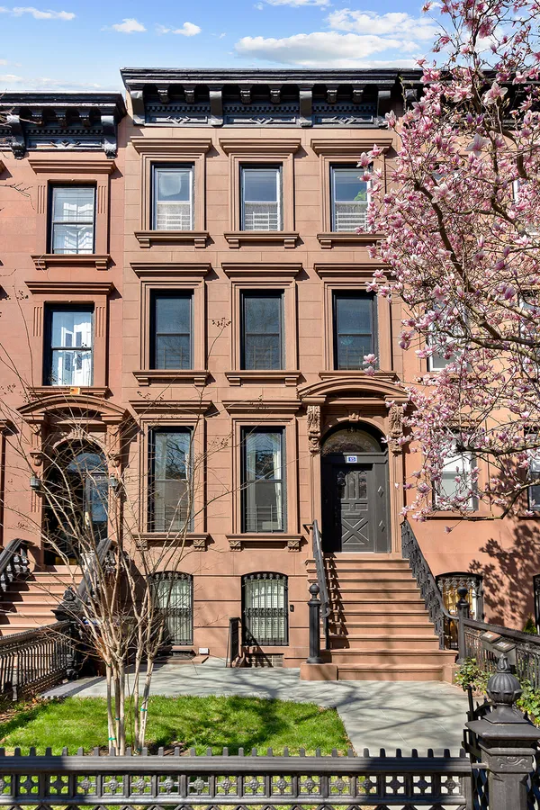 a front view of a residential apartment building with a yard