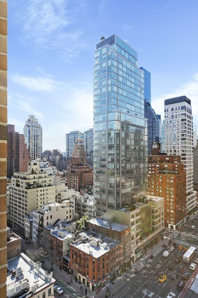 250 East 53rd Street, Unit 1001 Manhattan, NY 10022 - Photo 13 of 18 a city view with tall buildings