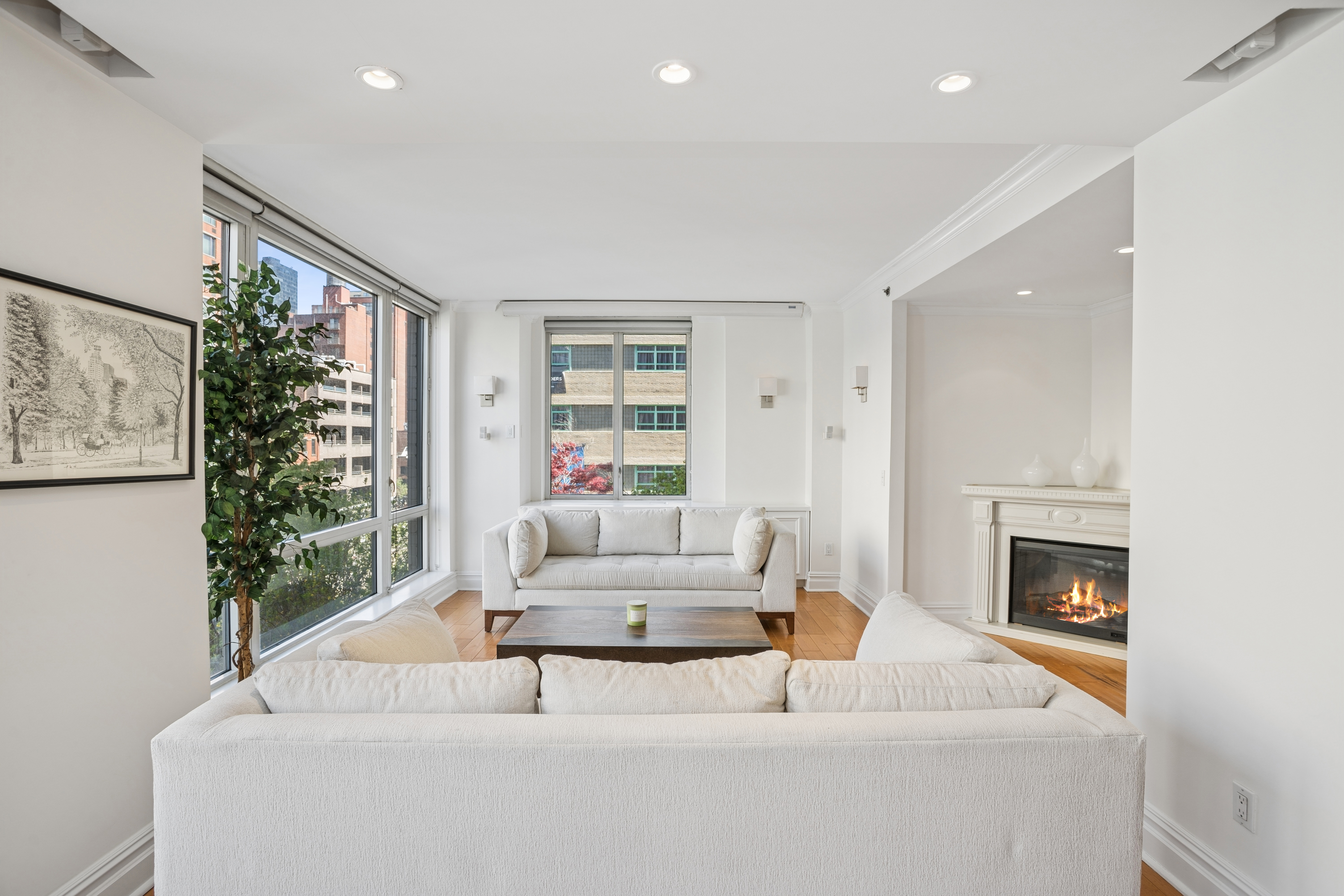 401 East 60th Street, Unit 4ABC Manhattan, NY 10022 - Photo 12 of 18 a living room with furniture and a fireplace
