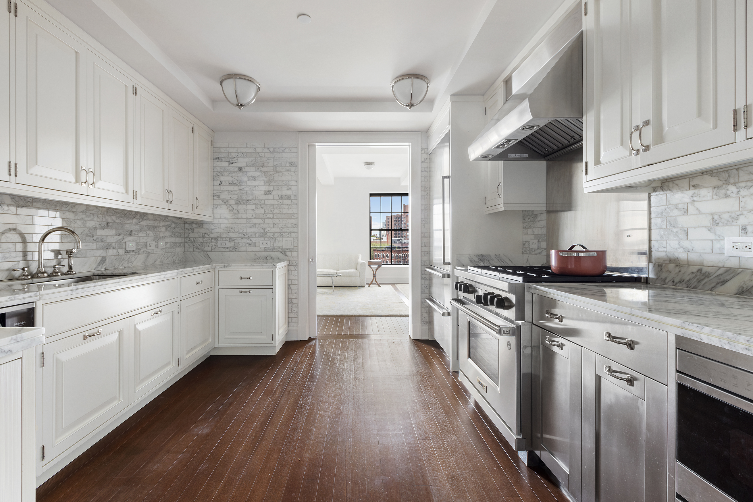 160 West 12th Street, Unit 78 Manhattan, NY 10011 - Photo 6 of 22 a kitchen with cabinets wooden floor and stainless steel appliances