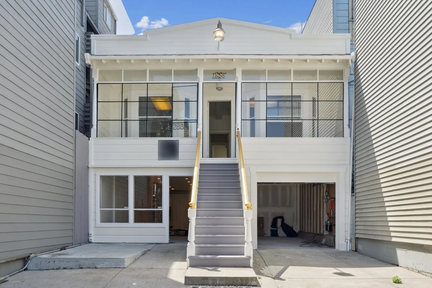 a view of an empty room with wooden floor and windows