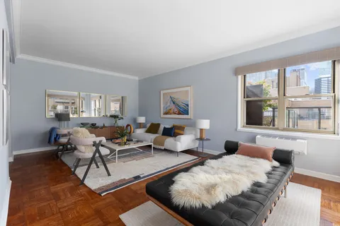 a living room with furniture and large window