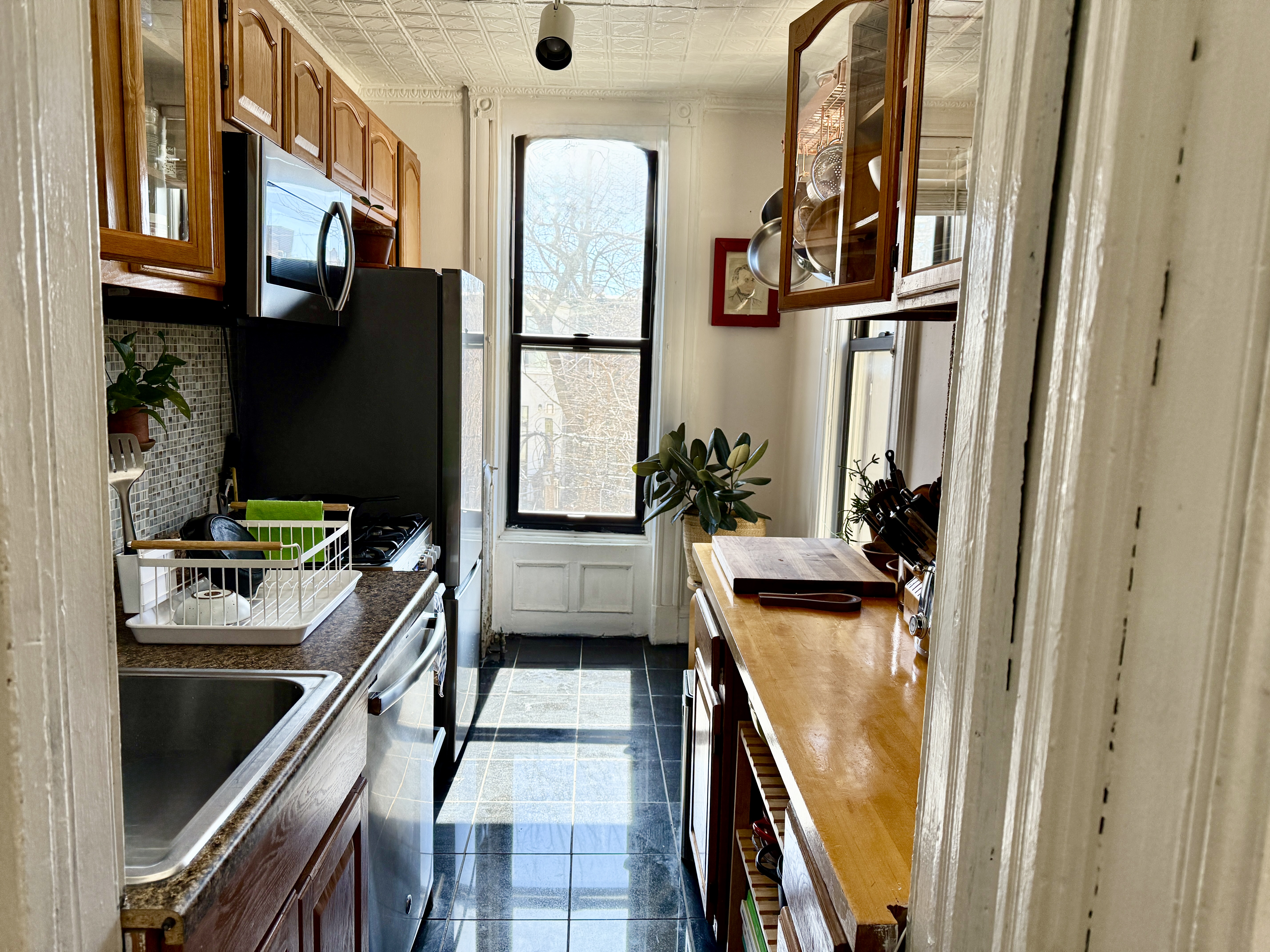 814 Putnam Avenue, Unit 2 Brooklyn, NY 11221 - Photo 2 of 8 a view of a kitchen with a stove and a refrigerator