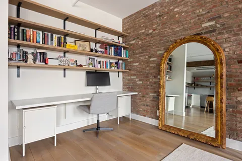 a workspace with furniture window and wooden floor