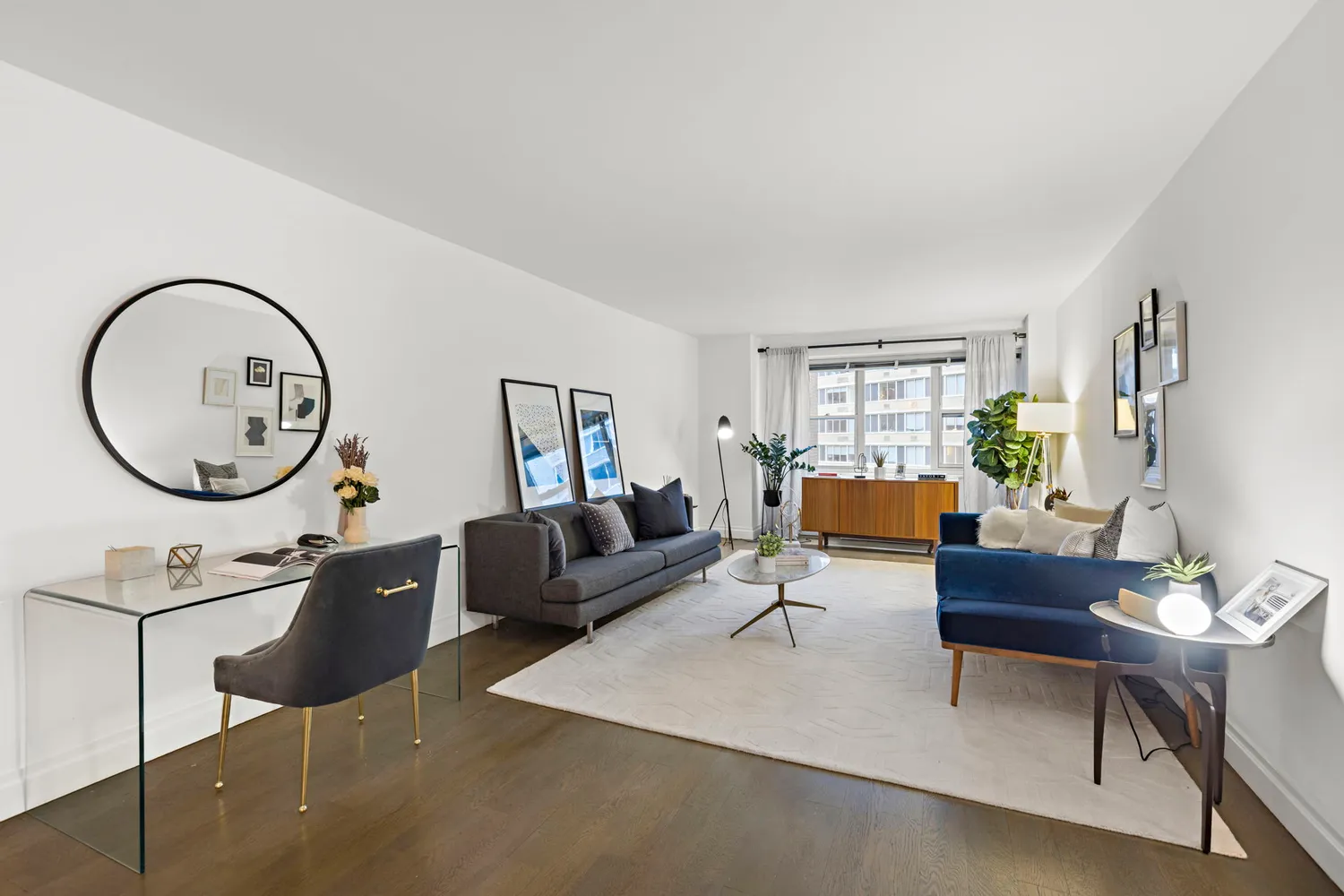 a living room with furniture a mirror and a window