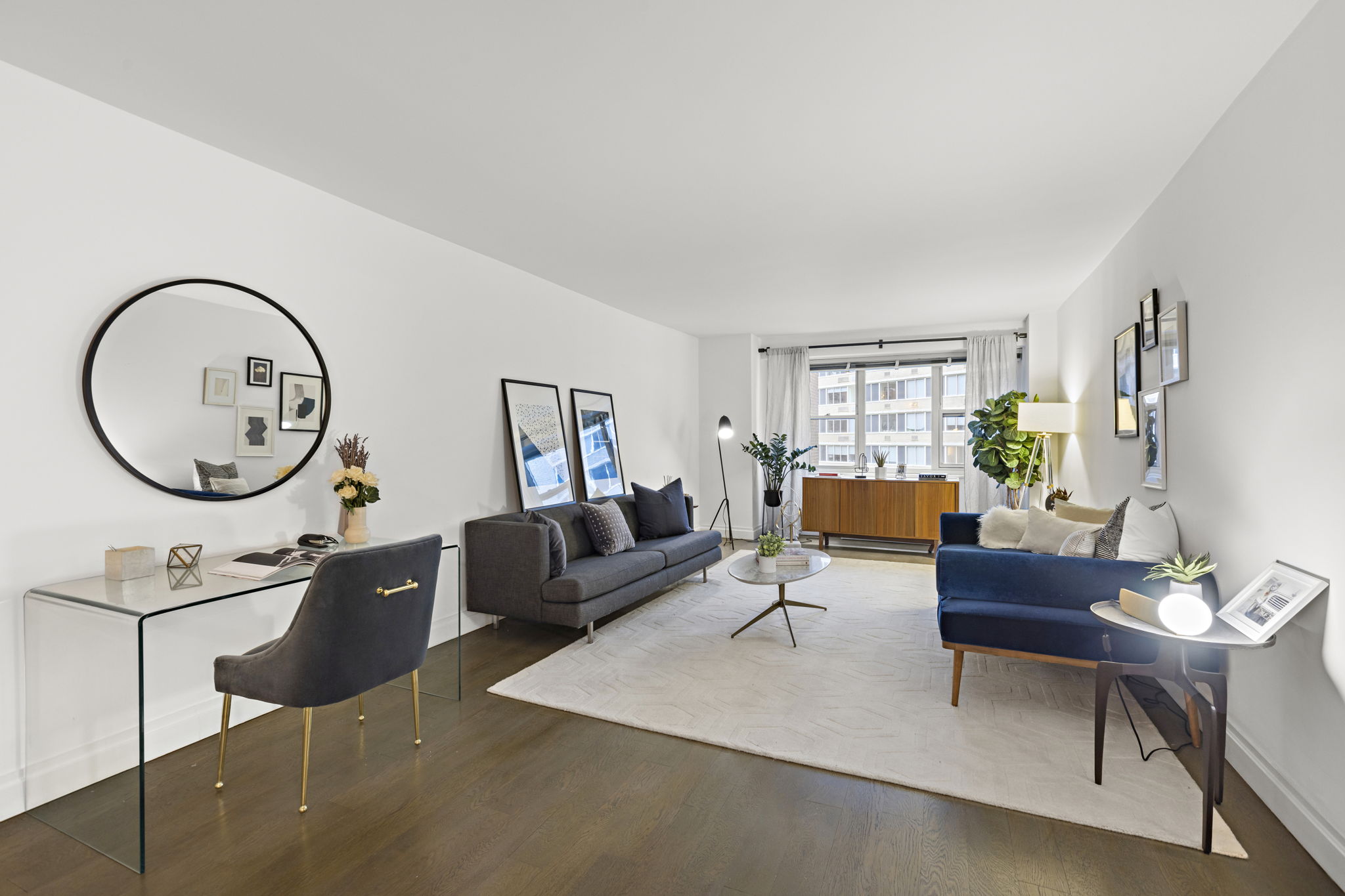400 East 54th Street, Unit 8A Manhattan, NY 10022 - Photo 6 of 20 a living room with furniture a mirror and a window