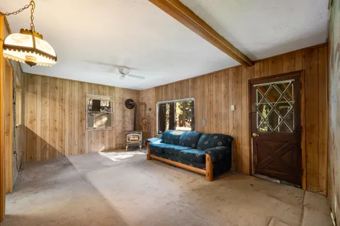 a living room with a couch and a dresser next to a window