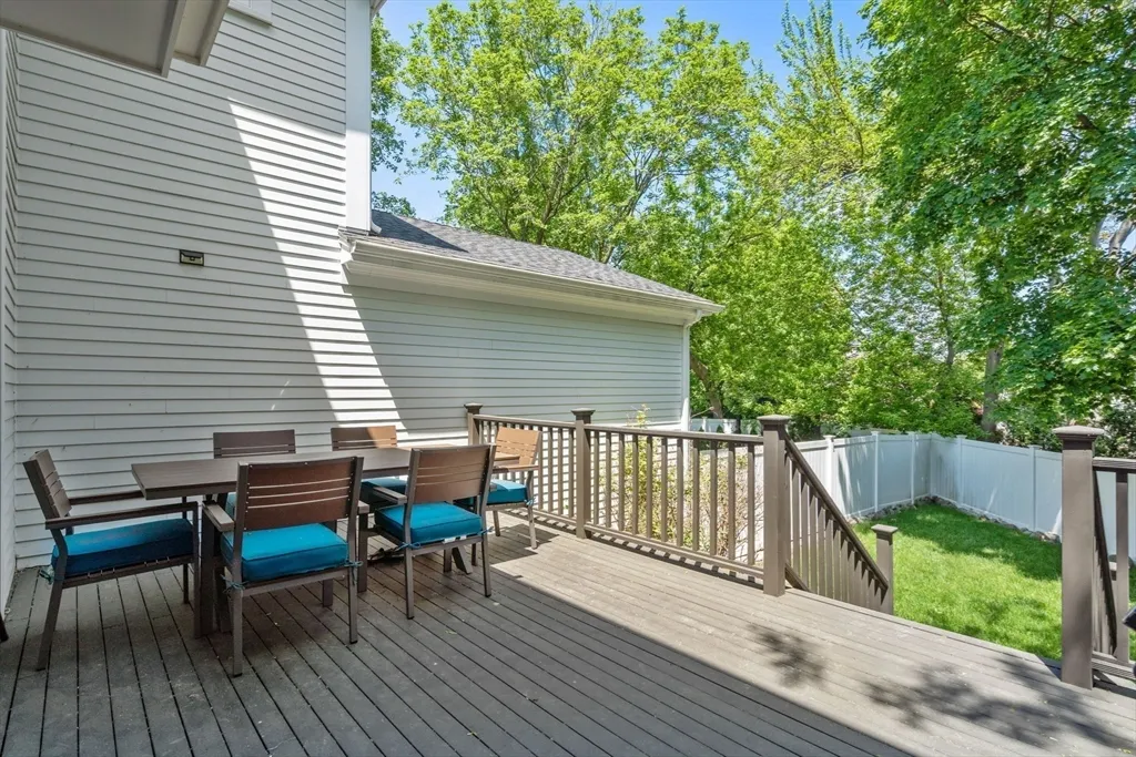 a view of a deck with two chairs and wooden floor