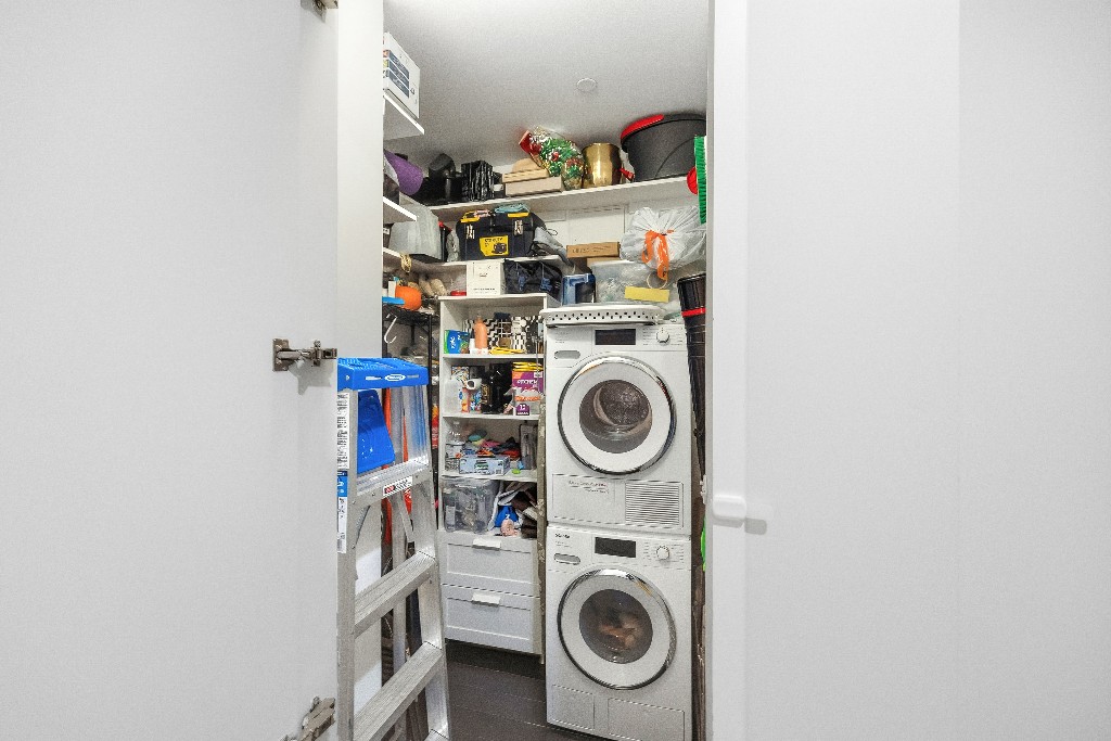 111 Fulton Street, Unit 824 Manhattan, NY 10038 - Photo 27 of 35 a utility room with dryer and washer