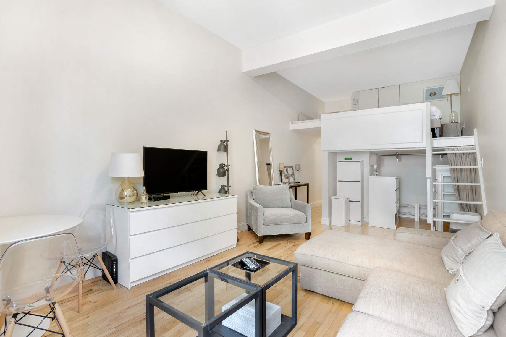 310 East 23rd Street, Unit 7C Manhattan, NY 10010 - Photo 8 of 18 a living room with furniture and a flat screen tv