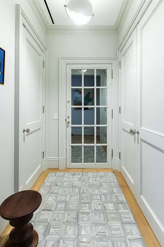 390 West End Avenue, Unit 7DS Manhattan, NY 10024 - Photo 14 of 31 a view of a hallway with wooden floor and a large window